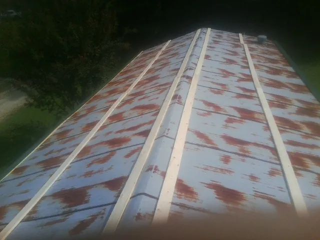Rusted metal roof panels with new wood purlins before replacement — Storm Damage Roof Repair in Pawcatuck by Roofing Brothers