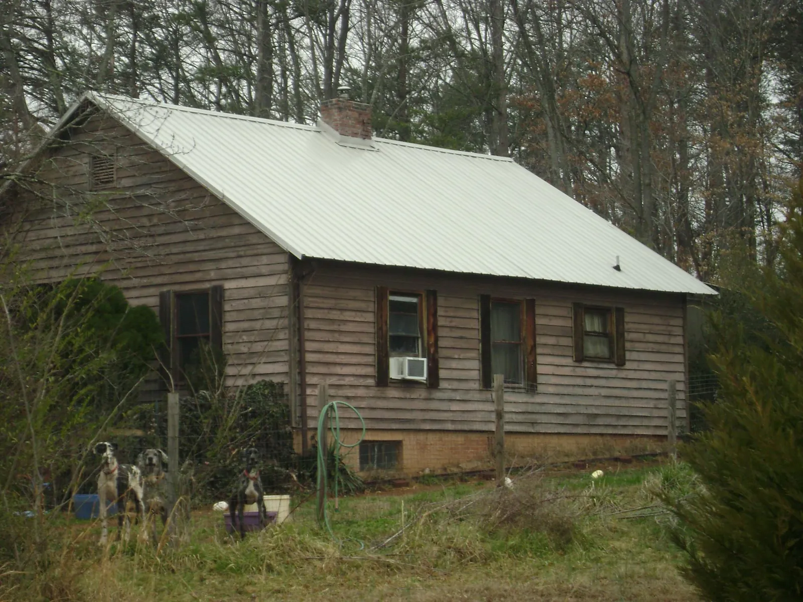 White metal roof on an old wood sided farmhouse, from a Metal Roof Installation job in Pawcatuck